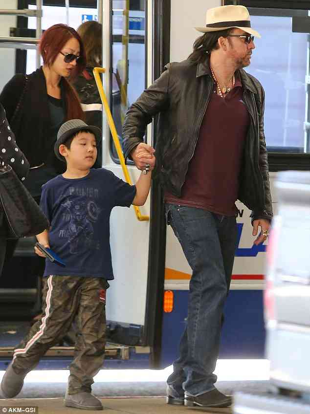 Nicolas Cage rocks a brand new ponytail as he heads to China to shoot Outcast | Daily Mail Online