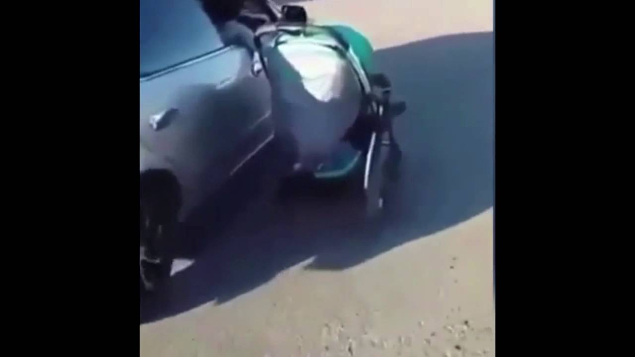 Woman pushes toddler in pram while driving her CAR - YouTube