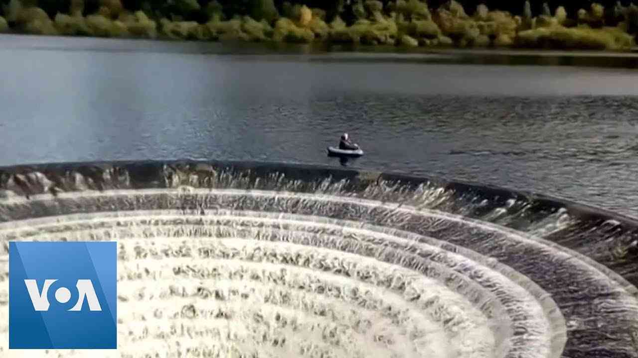 Fishermen Float Close to 'Plughole' on English Reservoir - YouTube