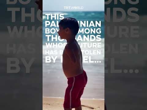 Palestinian boy with amputated limbs plays on Gaza Beach